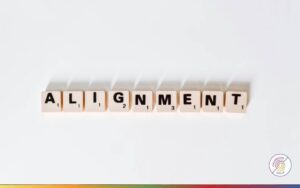 Alignment spelled out in letter tiles, representing shared purpose, clarity and direction within teams and organisations.